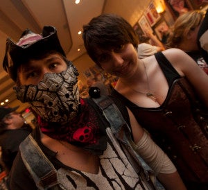 Two friends pose in costumes at Monster Mania.