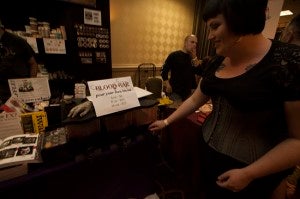 Kate from Philadelphia, Pa. shows off the different flavors and types of blood for sale at her stall. One of her favorite bloods is mouth blood, which has a sweet taste and sells for $6 an ounce.