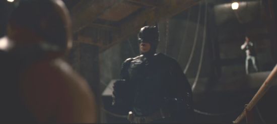 Batman backing away from Bane