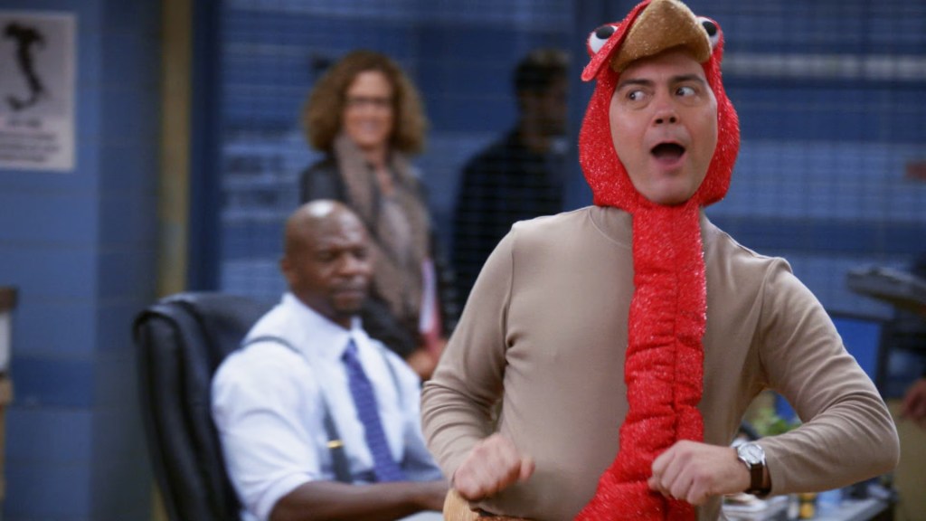 Joe Lo Truglio as Charles wearing the Tommy Gobbler costume in Brooklyn Nine-Nine