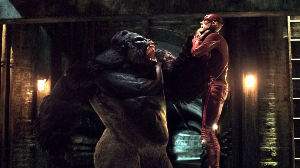 Grant Gustin as Barry Allen being chocked by Gorilla Grodd in The CW's The Flash