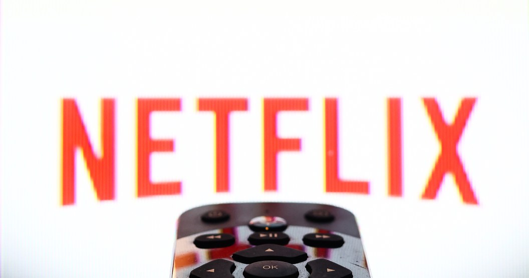 Netflix app displayed on a tv screen and a remote control