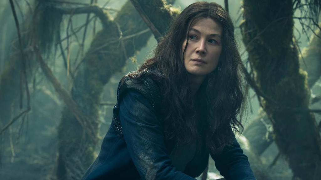 Rosamund Pike sitting in The Wheel of Time.