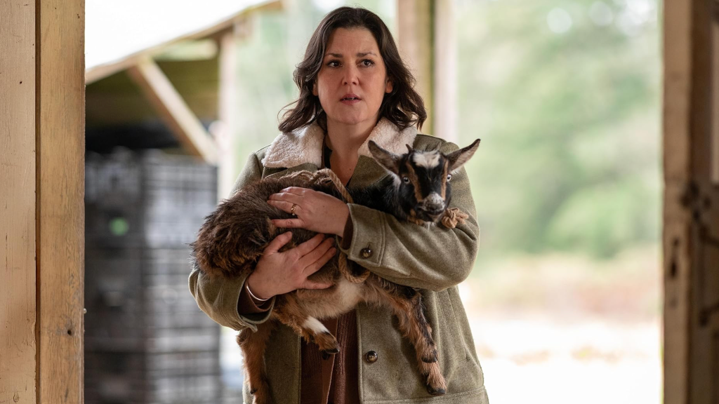 Melanie Lynskey holding a goat in Yellowjackets.