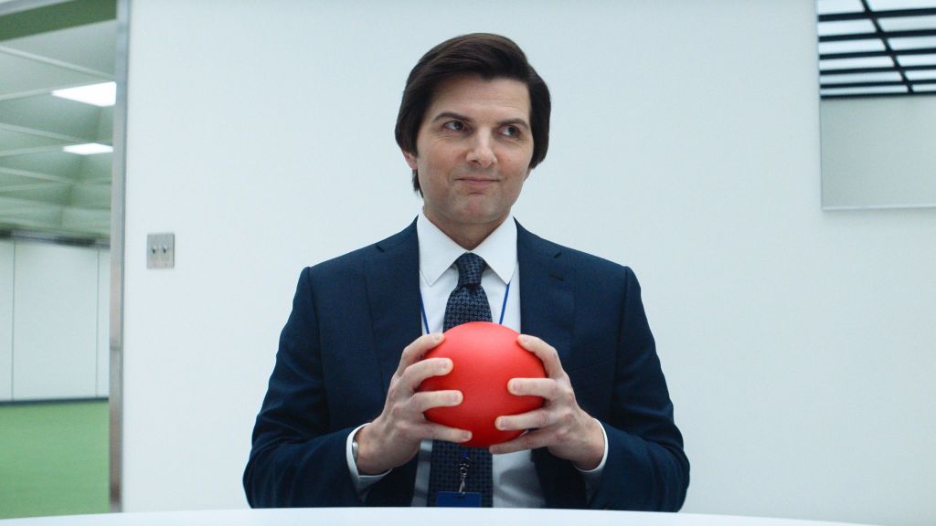 Adam Scott holding a red ball in Apple TV+'s Severance