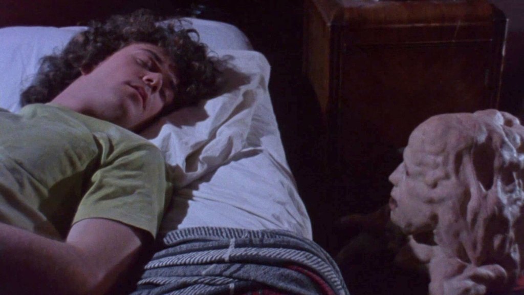 Duane Bradley sleeping as Belial watches in Basket Case.