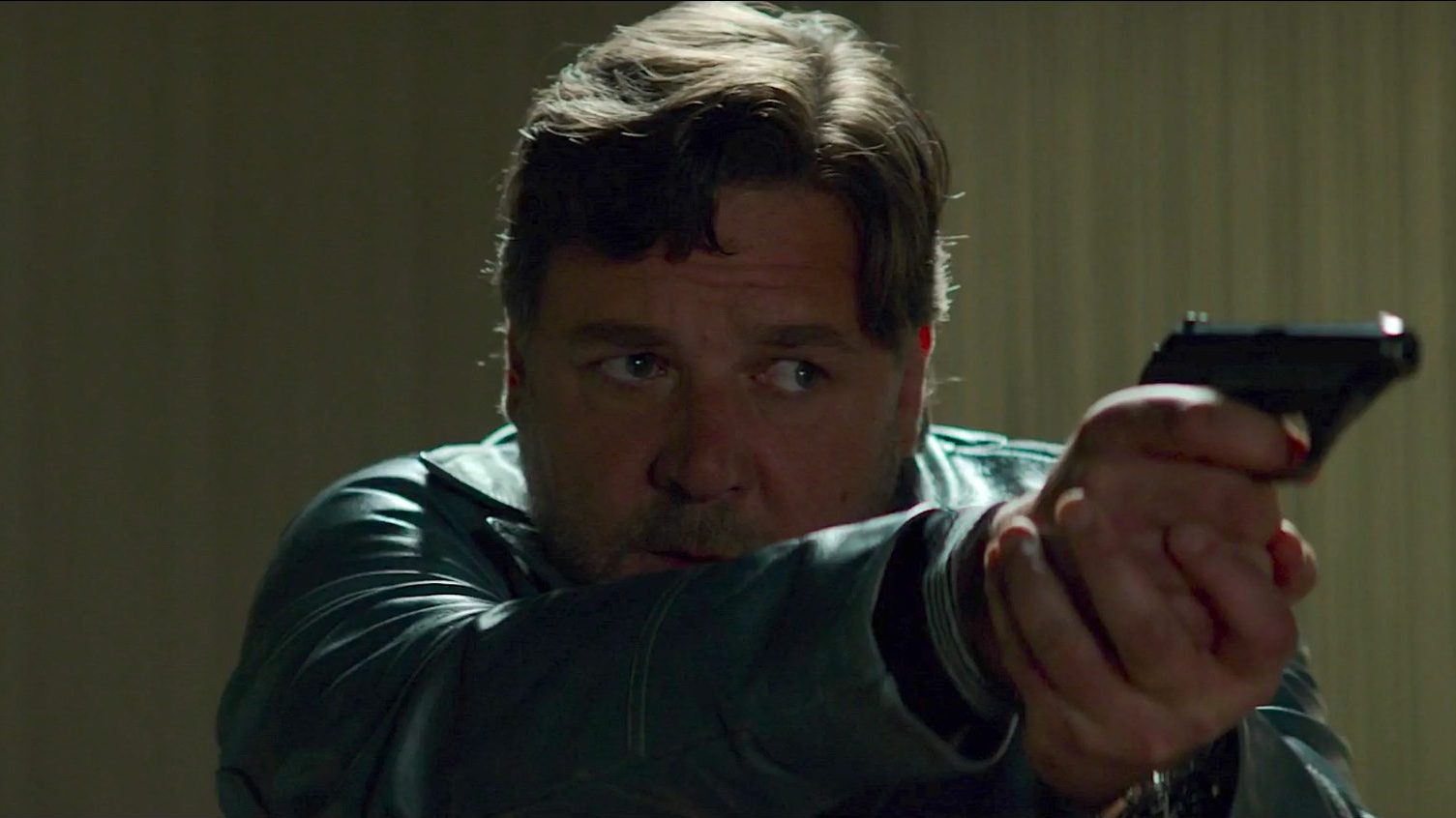 Russell Crowe aims a gun The Nice Guys