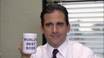 Steve Carell as Michael Scott hold a Best Boss mug in The Office
