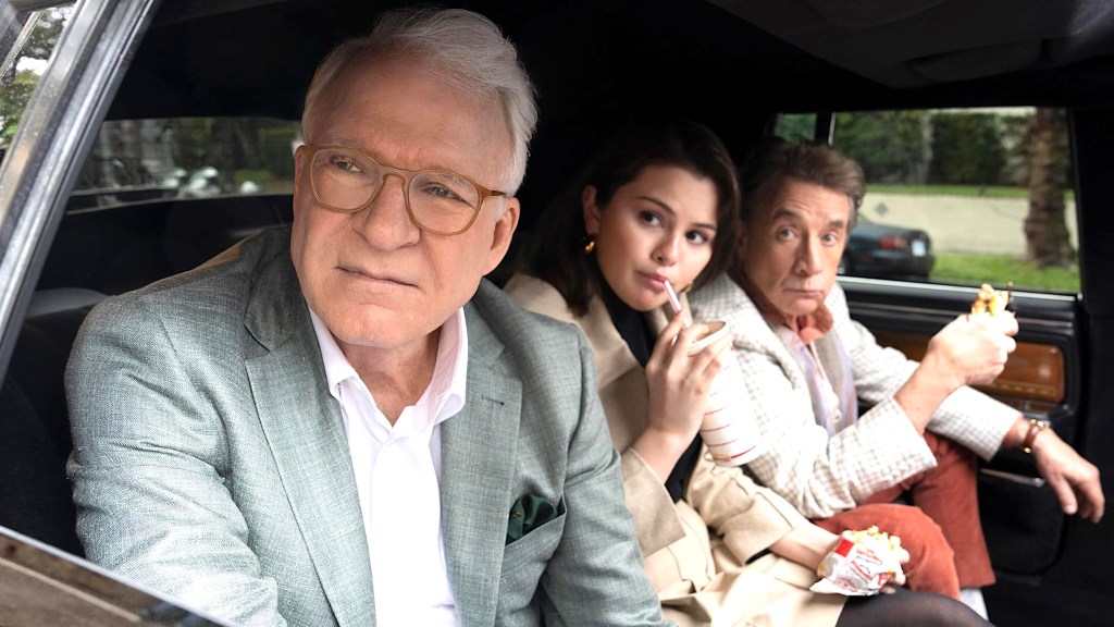 Steve Martin, Selena Gomez, and Martin Short sitting in backseat of car eating fast food in Only Murders in the Building