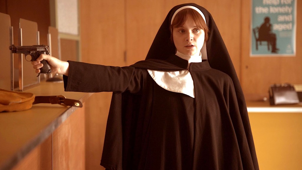 Lola Petticrew in nun outfit holding a gun in Say Nothing