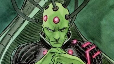 Brainiac starring with his hands clenched together.
