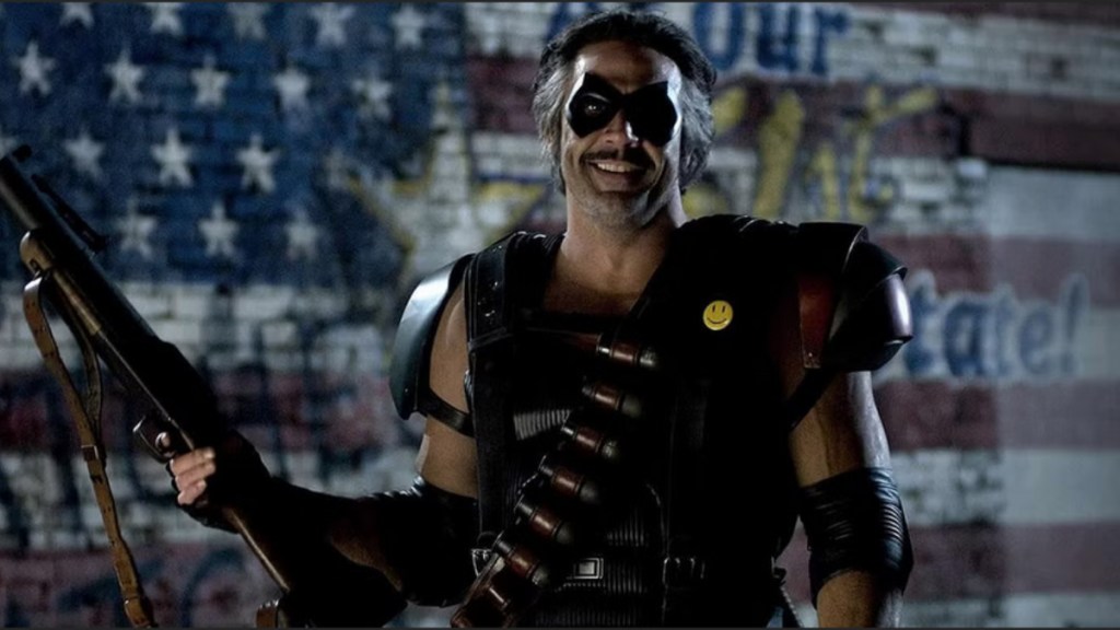 A smiling Comedian holding his grenade launcher from Watchmen