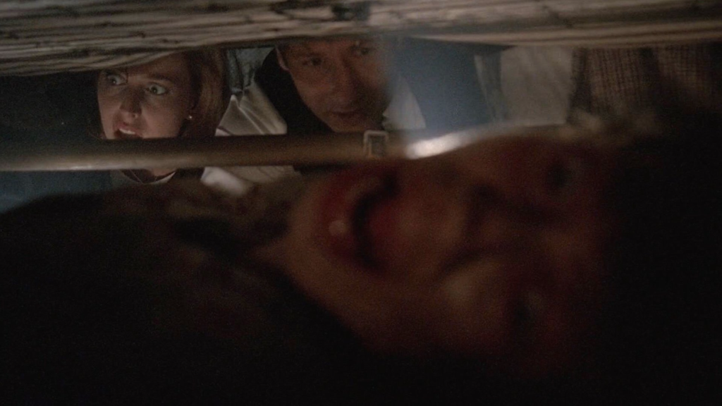 Mulder and Skully find the Peacock mother under a bed