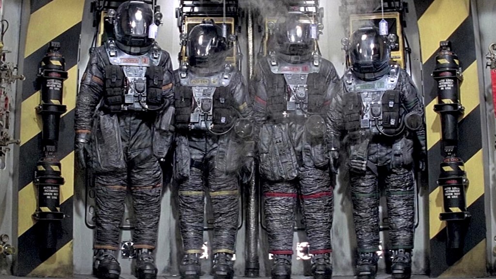 Line of people in black spacesuits in Event Horizon