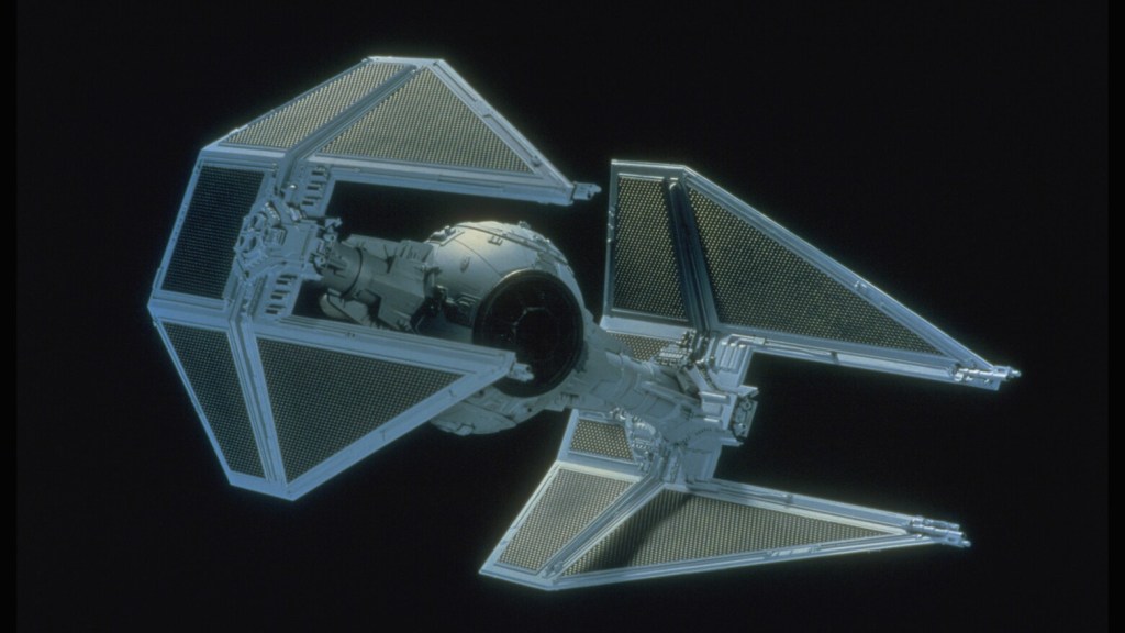 A TIE Interceptor flying through space