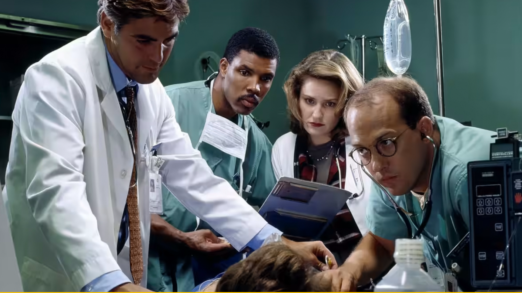 The cast of ER surround a patient 