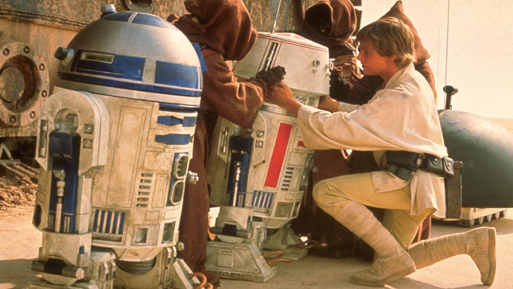 R5-D4 being inspected by Luke Skywalker