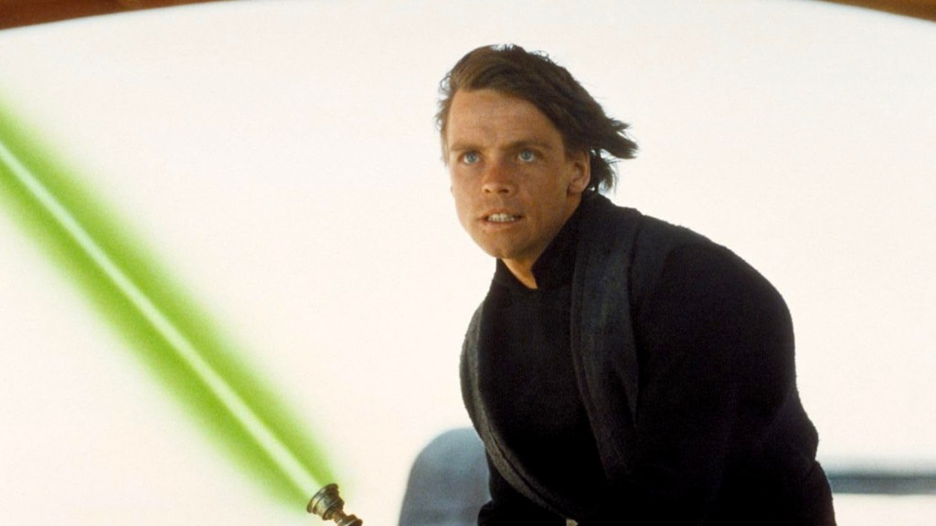 Mark Hamill as Luke Skywalker holding green lightsaber in Star Wars: Return of the Jedi