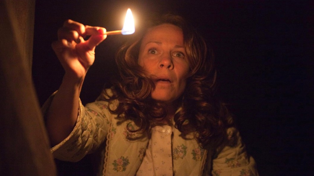 Lili Taylor holding a match in The Conjuring