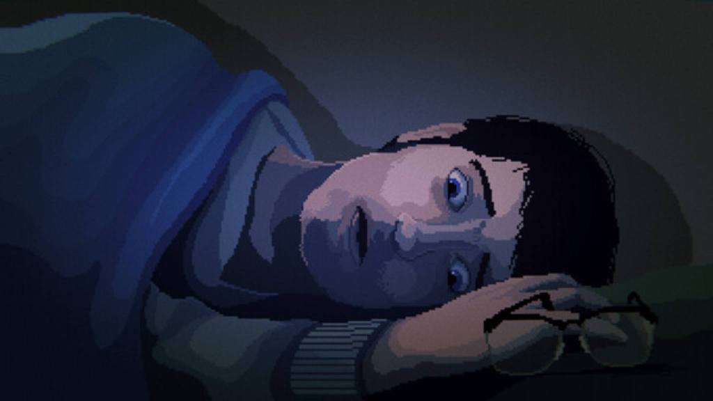 A shot of Phil lying in bed, his hand near his glasses