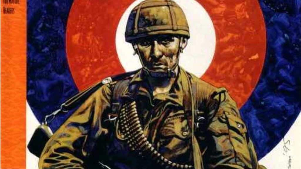A British soldier standing in full gear, a massive shooting target behind him, with his head in the center