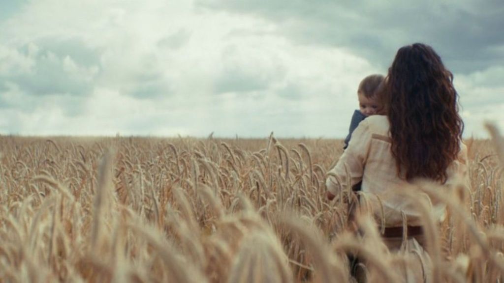 Bix holding her and Cassian's baby in the Andor finale