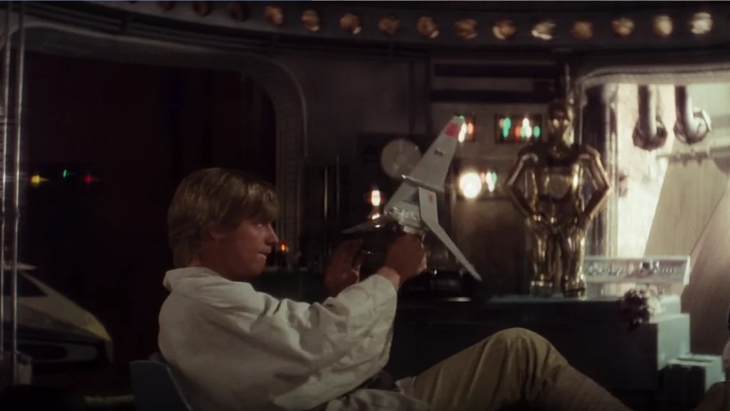 Luke Skywalker playing with T-16 Skyhopper model
