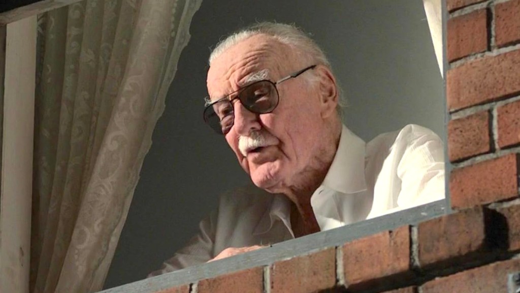 Stan Lee looking out a window