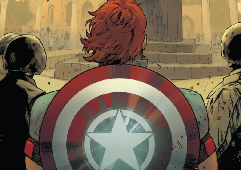 David Colton, wearing a Captain America shield watching the statue of Saddam Hussein get pulled down