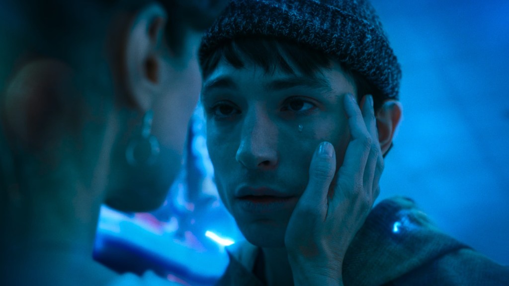 Ezra Miller as Barry Allen crying while being touched by his mother in The Flash (2023)