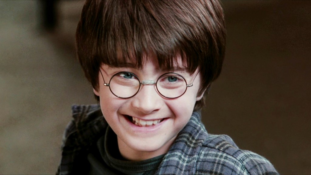 Harry Potter (Daniel Radcliffe) smiling in Harry Potter and the Philosopher's Stone