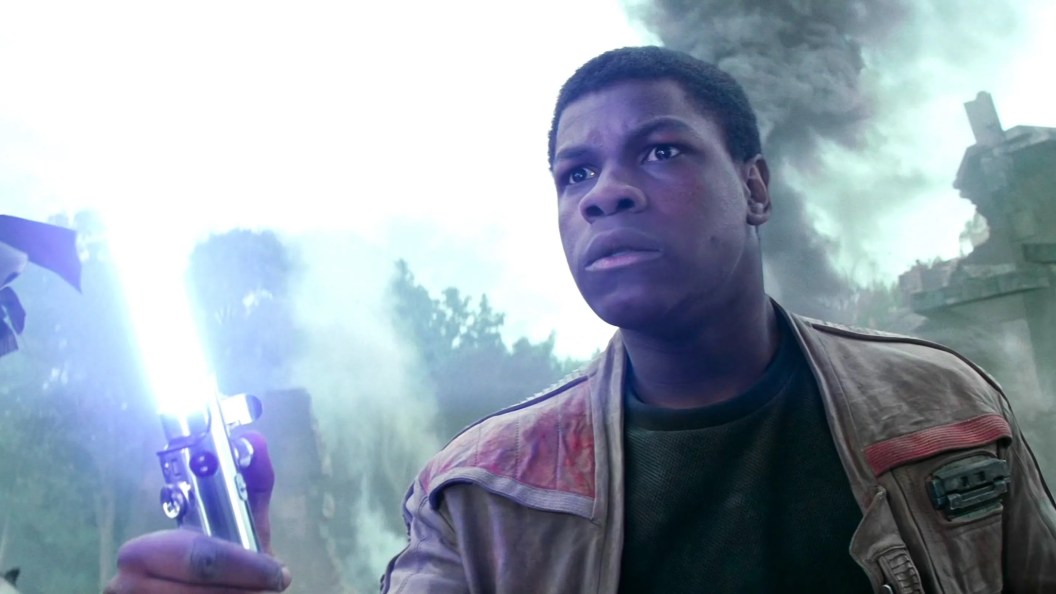 John Boyega as Finn with lightsaber in Star Wars Force Awakens