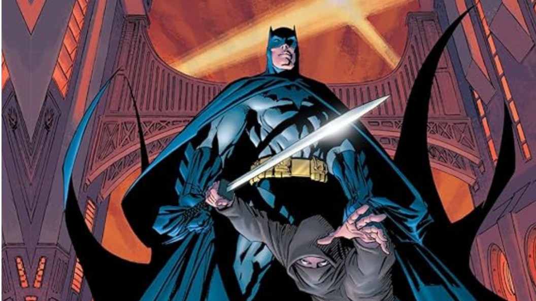 Batman standing on a ledge with a ninja under him