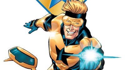 Booster Gold smiling and ready to fire hsi weapon with his robot Skeets next to him
