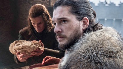 Ned Stark holding baby Jon Snow, and Kit Harington as Jon in Game of Thrones