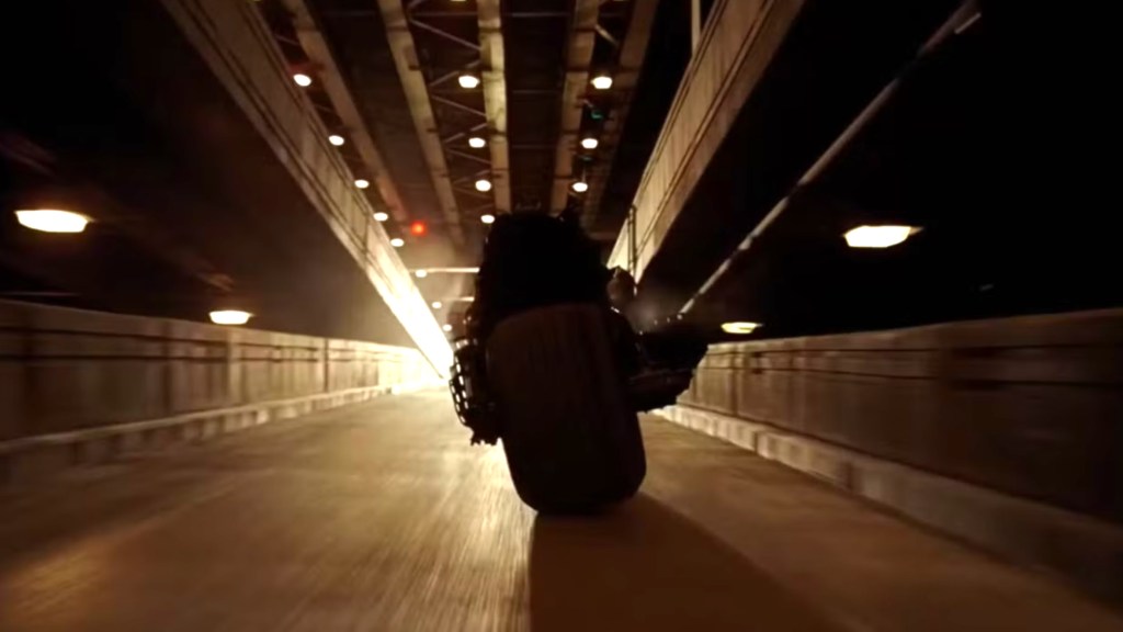 Batman riding the Batpod at the end of The Dark Knight