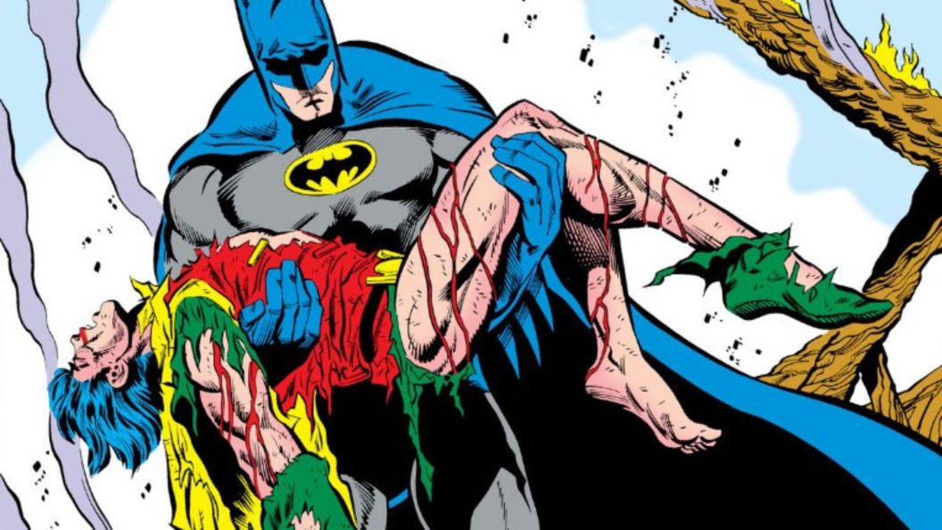 Batman holding a dead Jason Todd