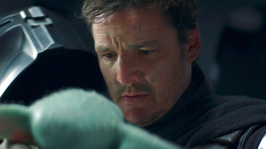 Din Djarin (Pedro Pascal), without his helmet on, looking at Grogu in The Mandalorian Season 2 finale