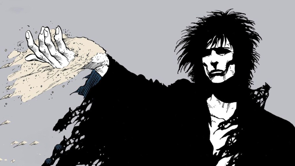 Morpheus holding his arm out, with sand blowing off his hand