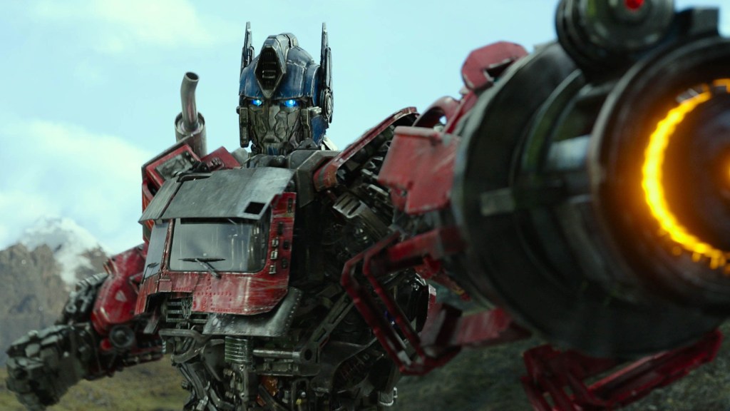Optimus Prime aims his gun arm in Transformers rise of the Beasts