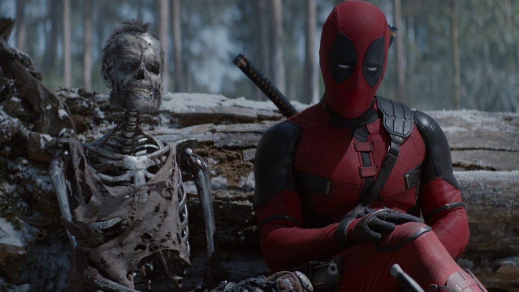 Ryan Reynolds as Deadpool sitting with Logan's skeleton in Deadpool & Wolverine