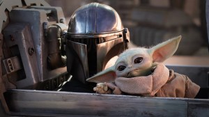 Pedro Pascal as Djin Djarin with Grogu in The Mandalorian