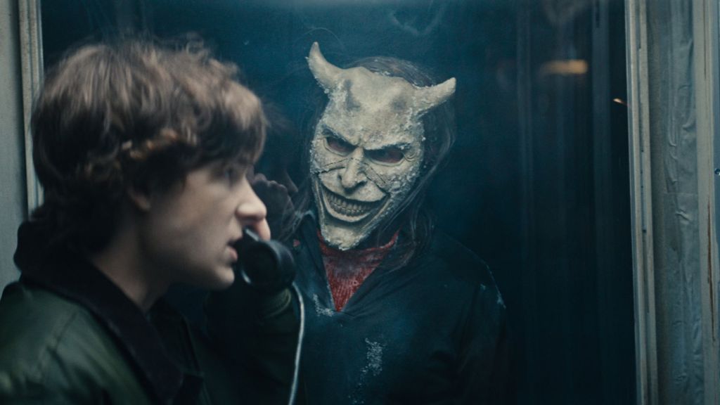 Ethan Harwke as the Grabber watching Mason Thames as Finney in The Black Phone 2