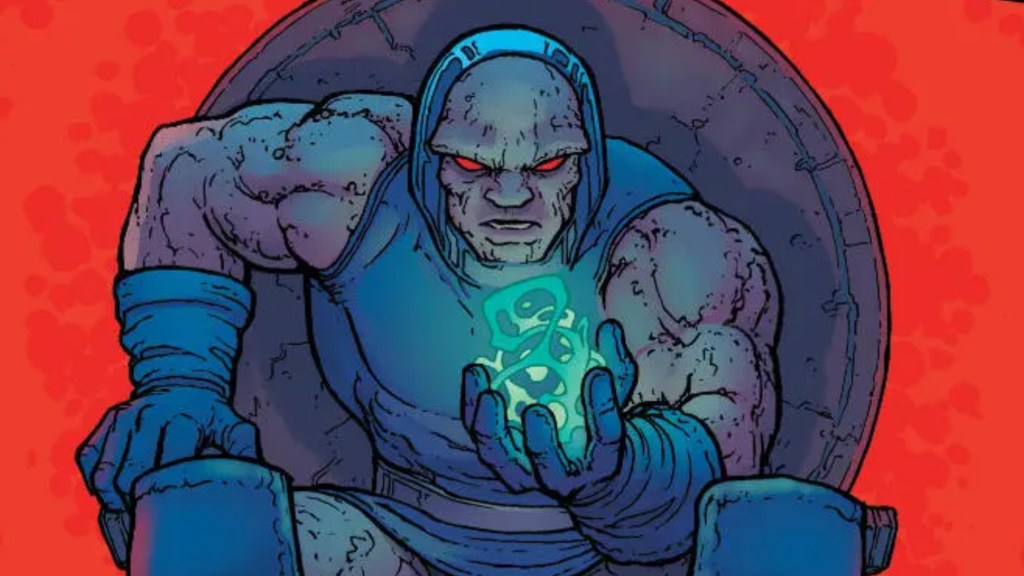 Darkseid sitting on his throne looking the Worlogog in his hand