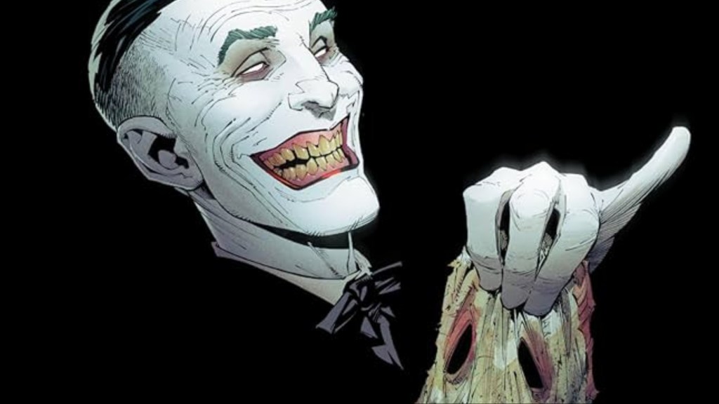 The Joker holding the rotting skin of his old face