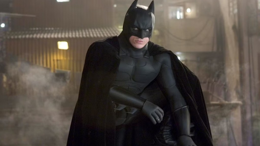 Christian Bale perched as Batman in Batman Begins (2005)