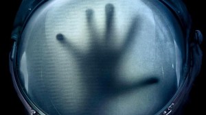 hand on space helmet on Life poster