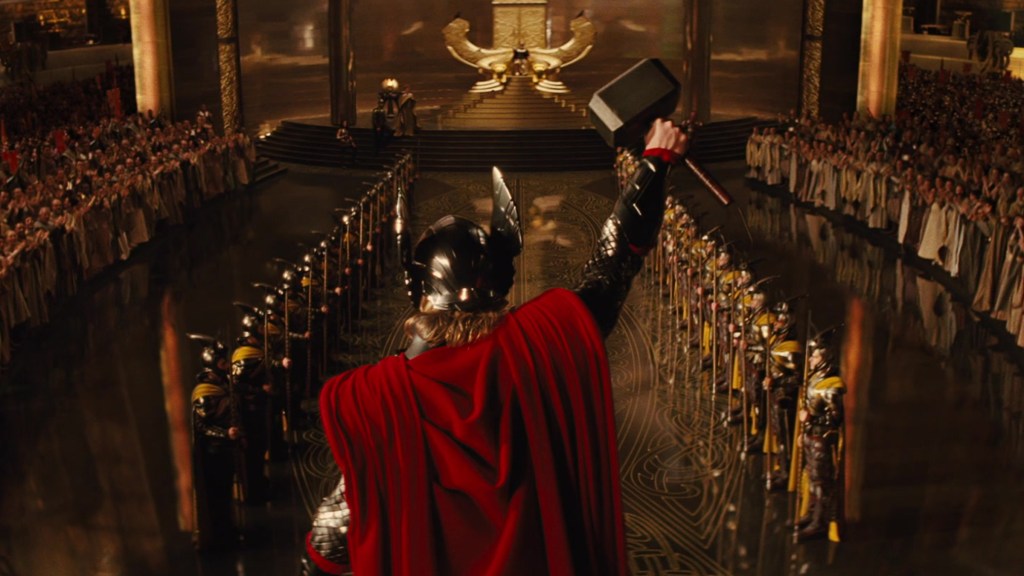Chris Hemsworth's Thor riasing Mjolnir in the throne room of Asgard in Thor (2011)
