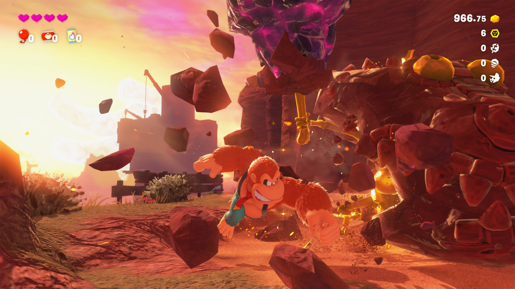 A screenshot from Donkey Kong Bananza, showing Donkey Kong smashing rocks.