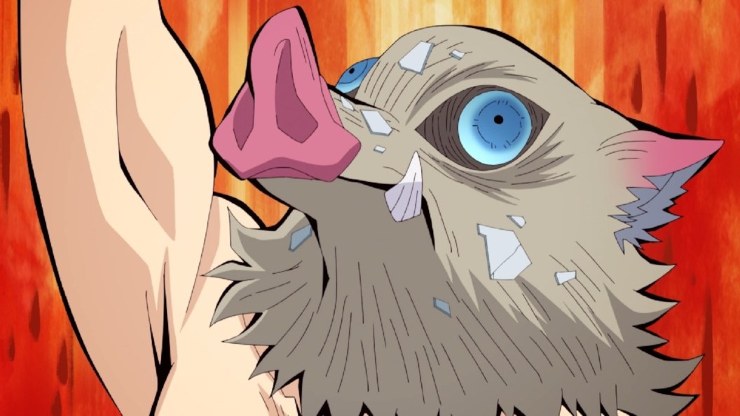 Inosuke raising his arm against an orange background in Demon Slayer